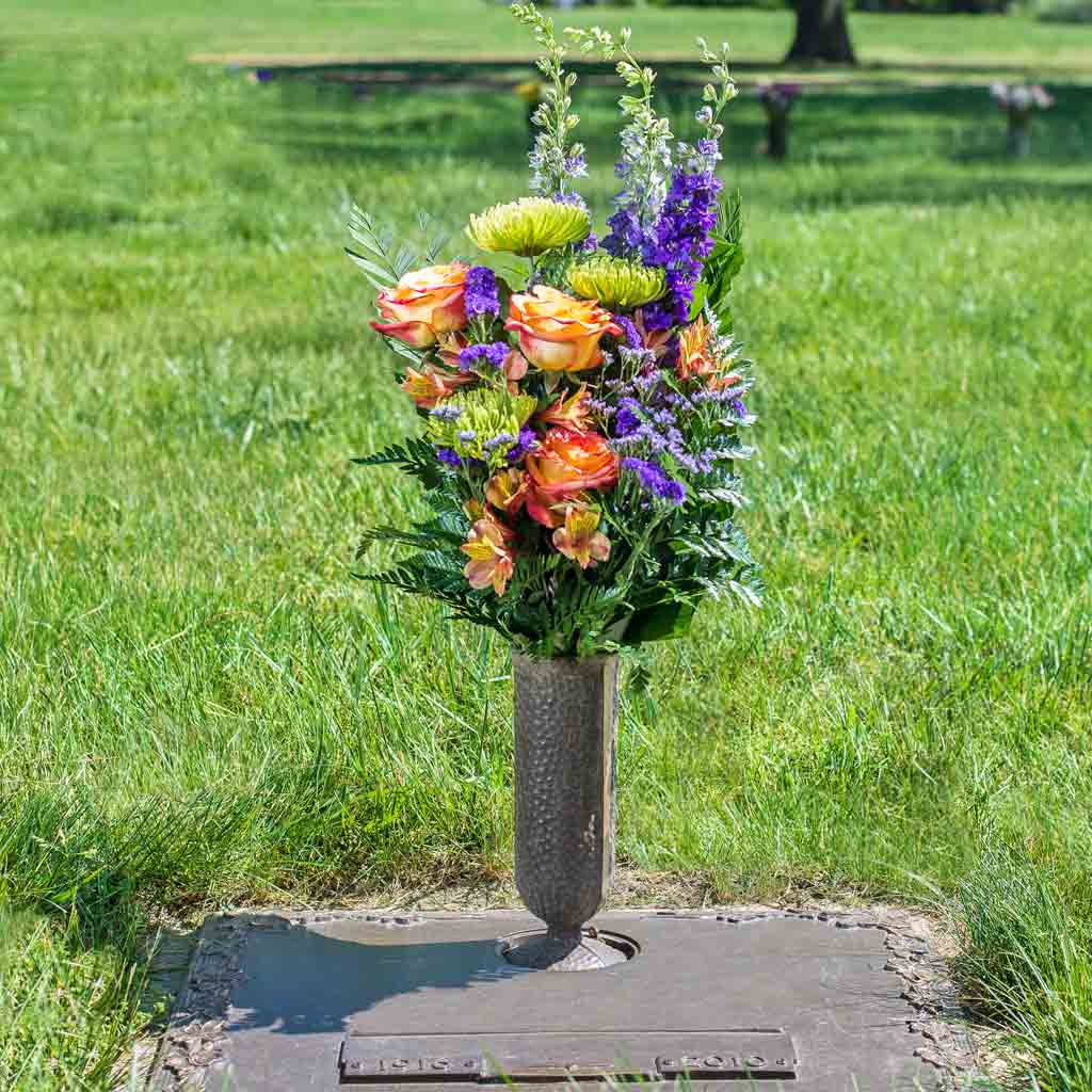 Fresh flowers delivered and placed at a gravesite